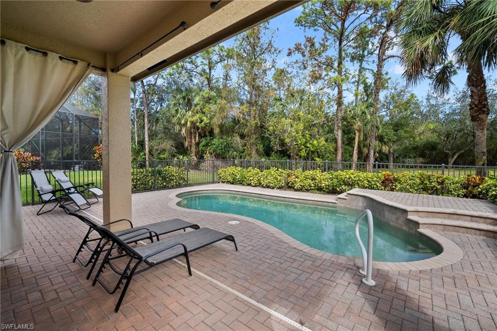 1384 Areca Cove Naples, FL 34119 - Photo 10 of 49 a view of a swimming pool with a lounge chair