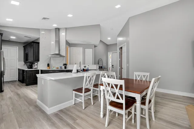 a living room with furniture and view of kitchen