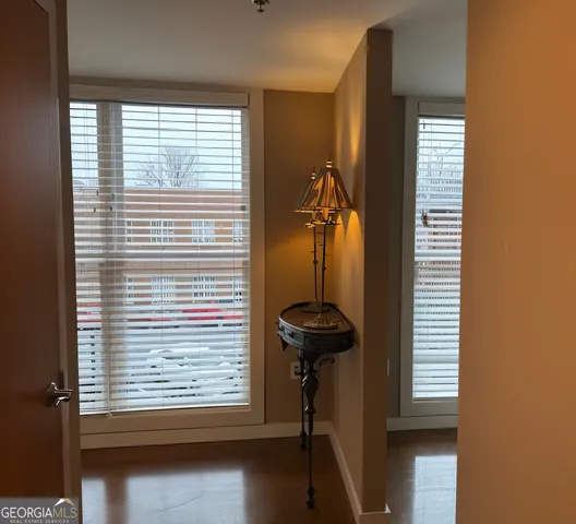 a view of a room with a window and brick walls