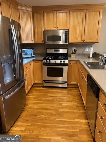 a kitchen with granite countertop a refrigerator stove and microwave