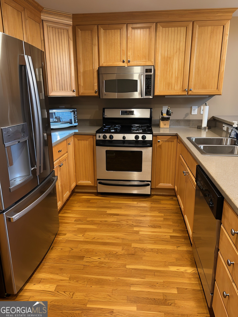 1133 Church Street, Unit 1 Covington, GA 30014 - Photo 8 of 26 a kitchen with granite countertop a refrigerator stove and microwave
