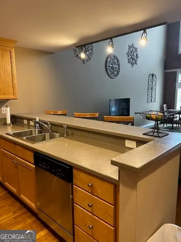 a utility room with a sink and a clock on the wall