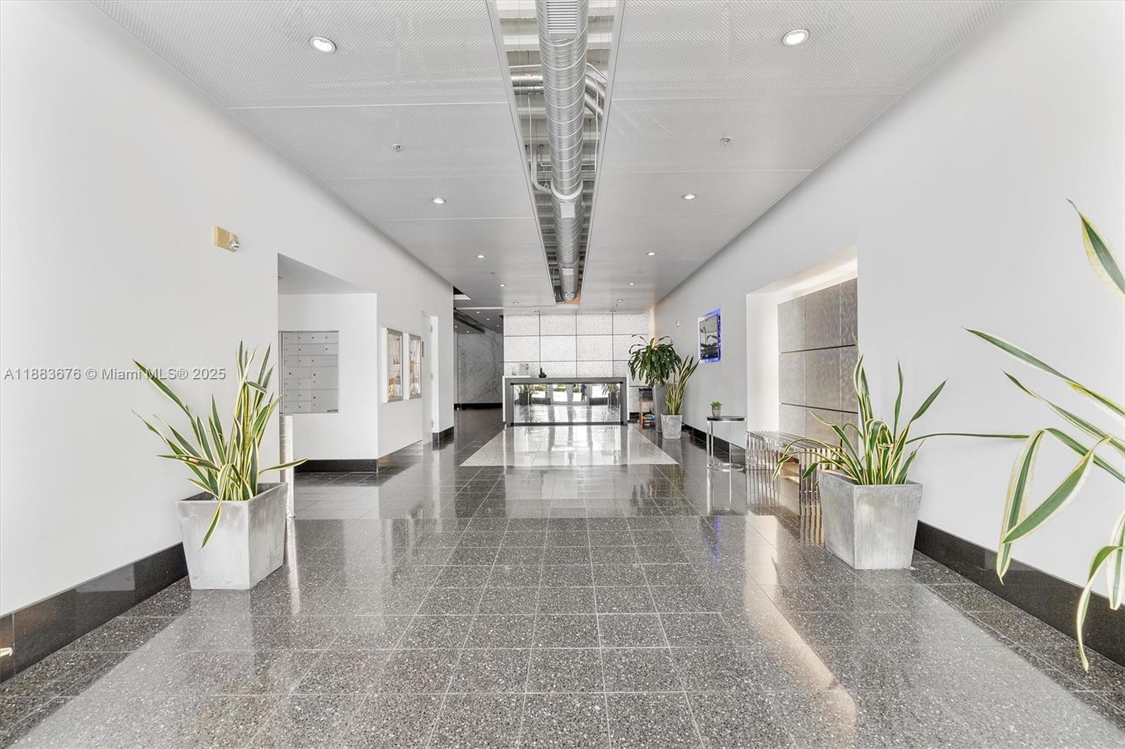8101 Biscayne Boulevard, Unit R515 Miami, FL 33138 - Photo 23 of 26 a lobby with furniture and a potted plant