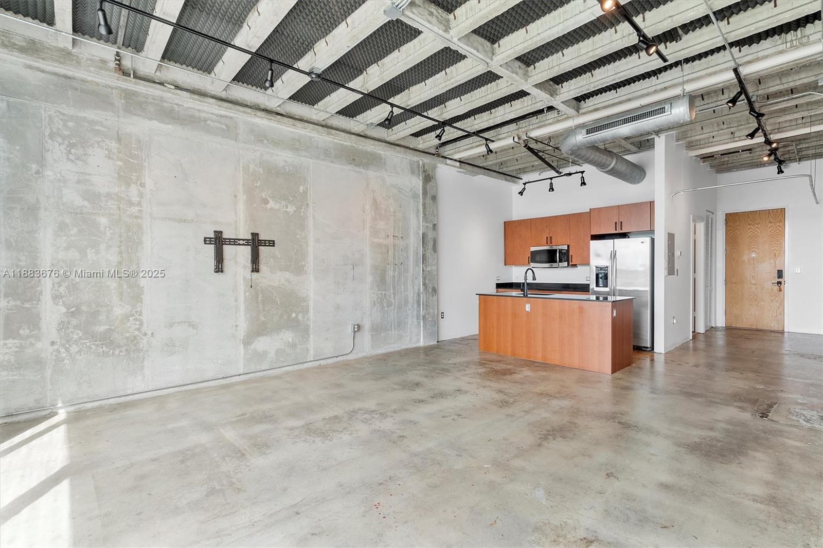 8101 Biscayne Boulevard, Unit R515 Miami, FL 33138 - Photo 6 of 26 a view of empty room with wooden cabinet