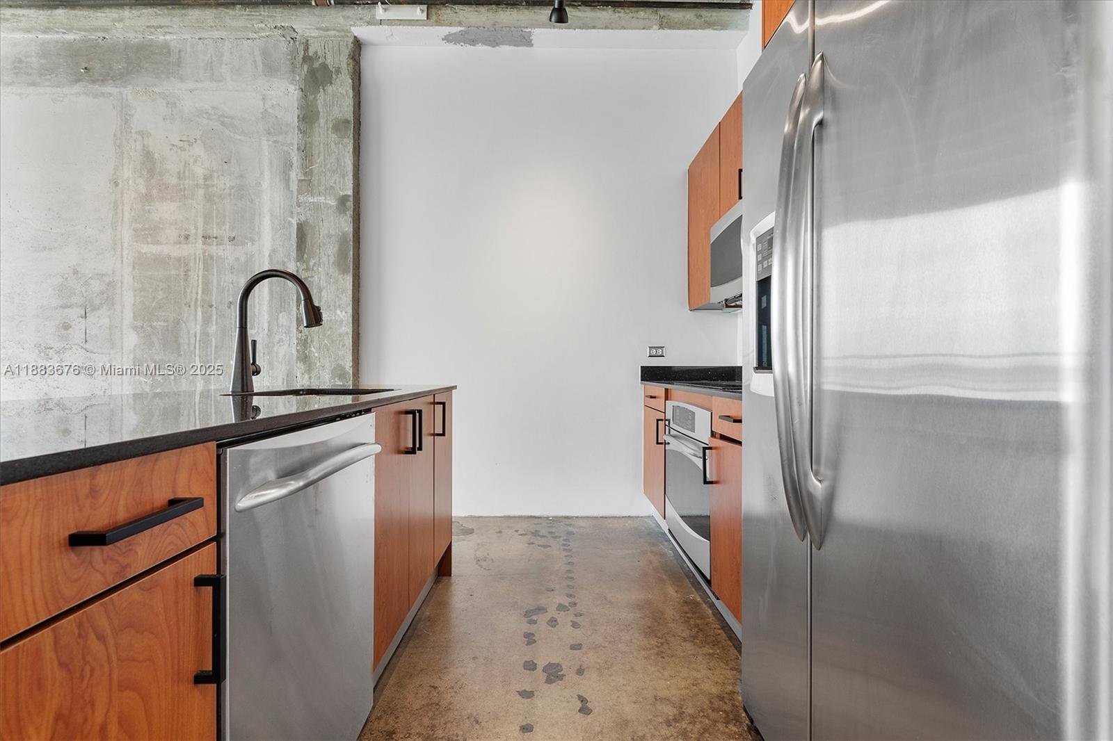 8101 Biscayne Boulevard, Unit R515 Miami, FL 33138 - Photo 10 of 26 a kitchen with a refrigerator and a sink