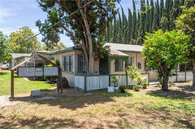a view of a house with a yard and tree s