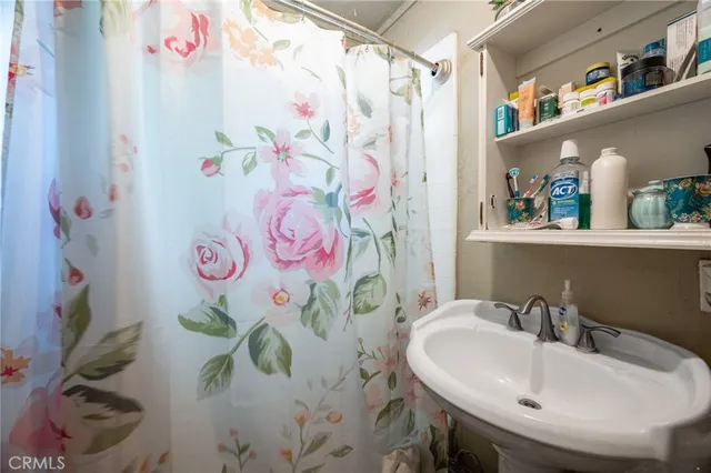 a bathroom with a sink and mirror with painted walls