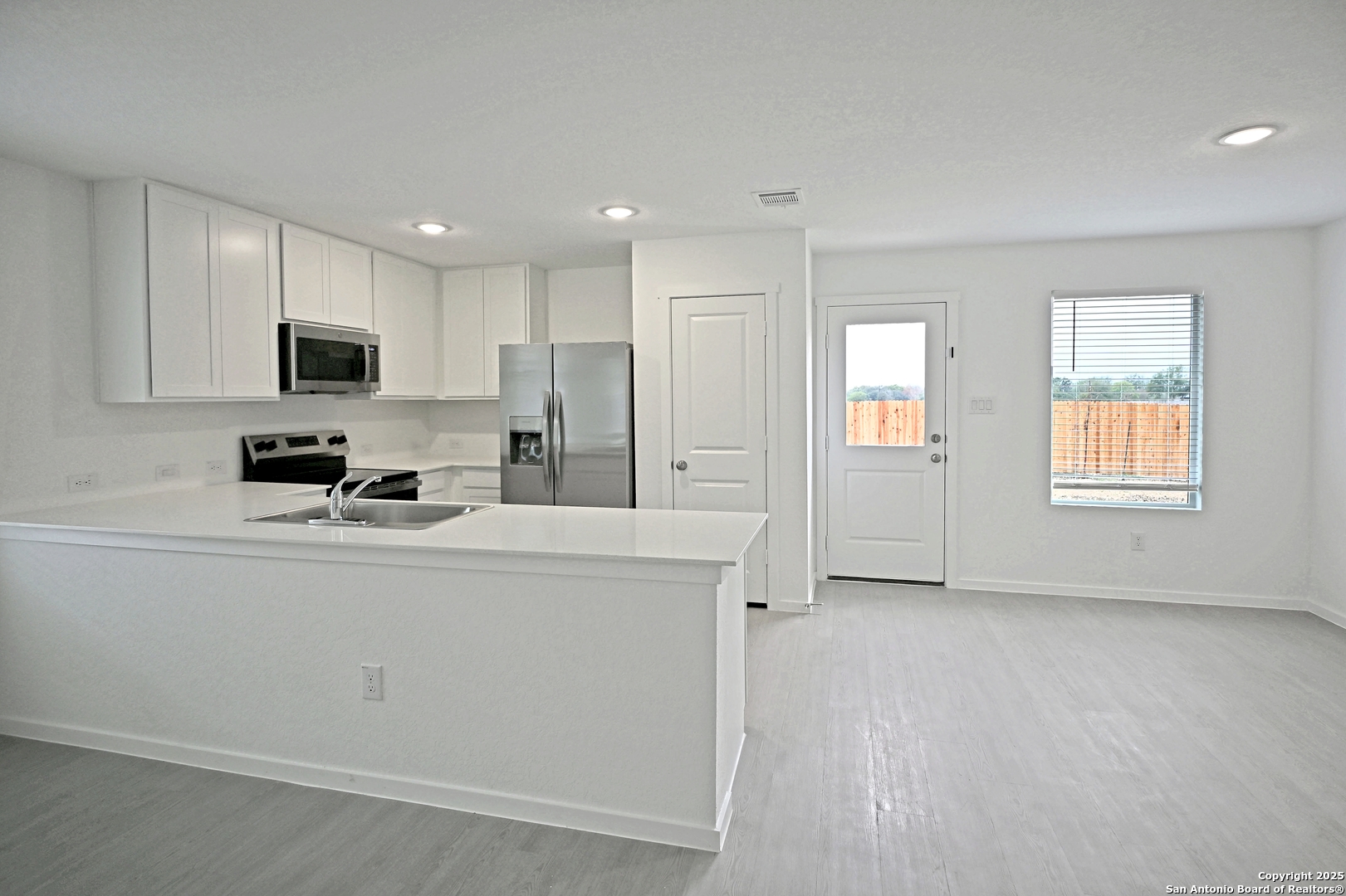 3817 Low Tide Seguin, TX 78155 - Photo 11 of 24 a kitchen with stainless steel appliances a refrigerator sink and microwave