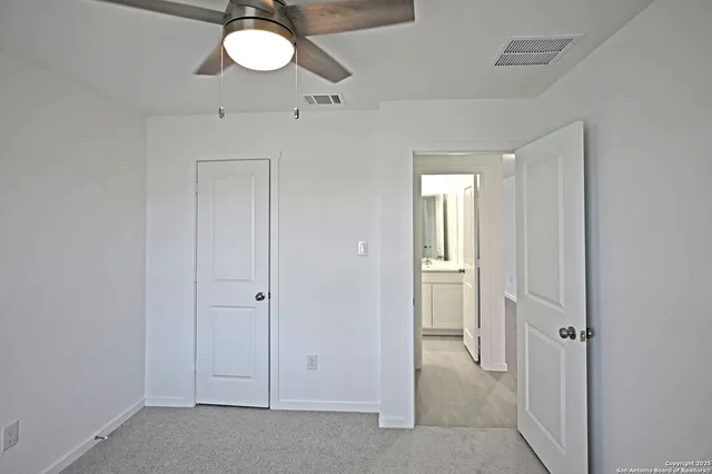 a view of a chandelier fan and entryway