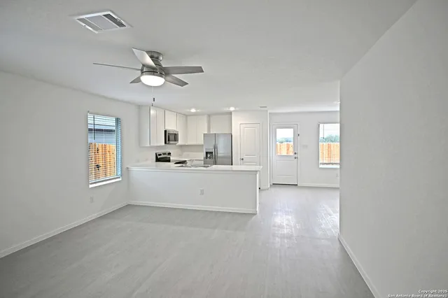 a view of a kitchen with microwave and cabinets