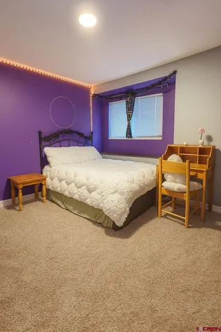 a bedroom with a bed and a table