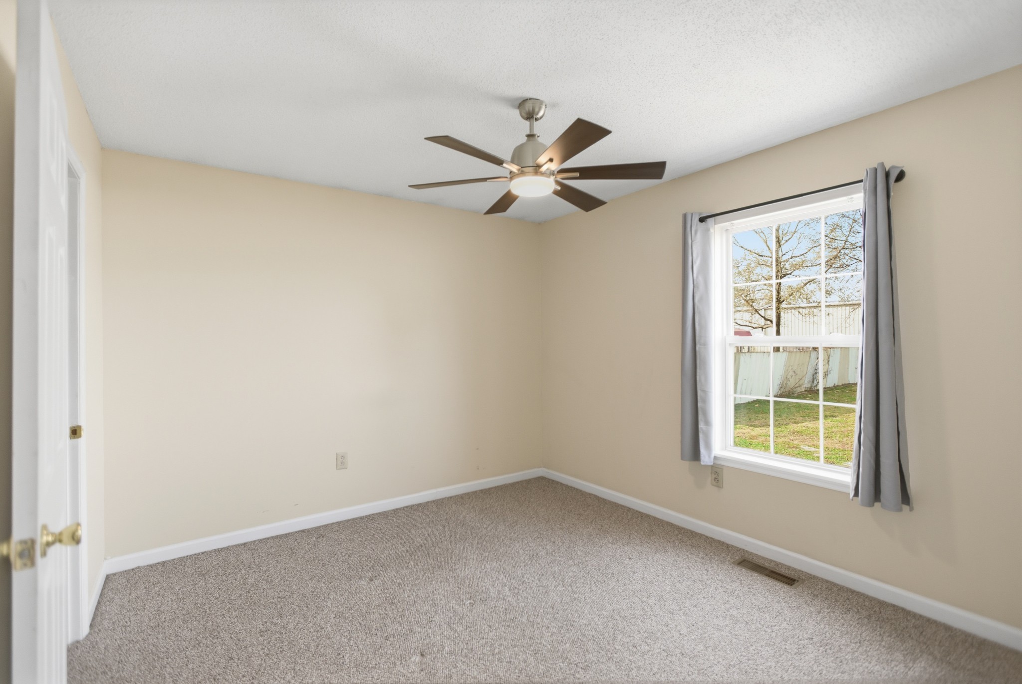 206 Weaver Street Tullahoma, TN 37388 - Photo 15 of 40 an empty room with a window and a fan
