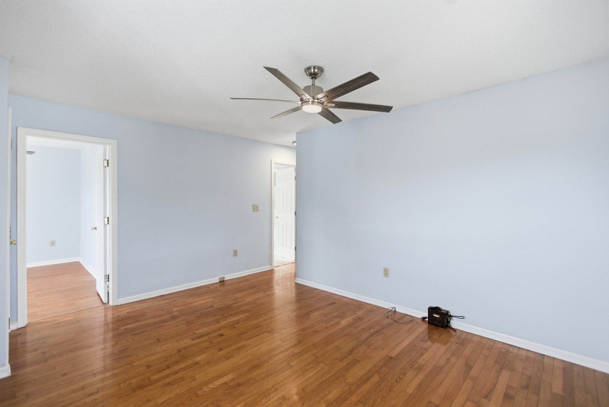 206 Weaver Street Tullahoma, TN 37388 - Photo 9 of 40 an empty room with wooden floor and a ceiling fan