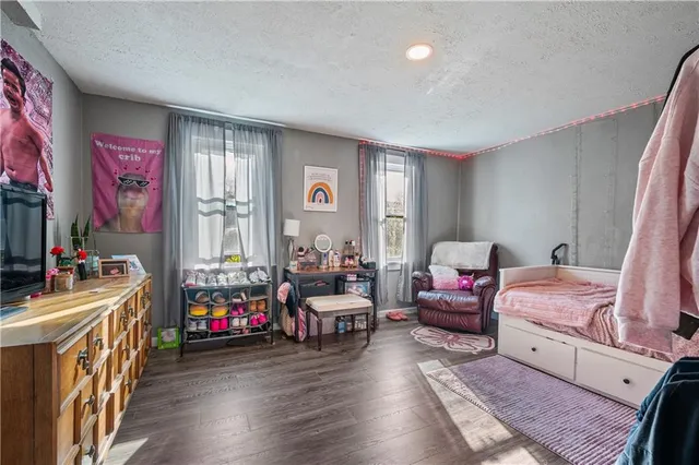 a bedroom with furniture and a wooden floor