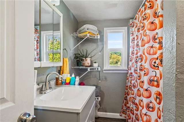 a bathroom with a sink a vanity and a window
