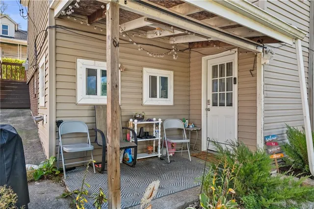 a view of a patio with table and chairs and potted plants