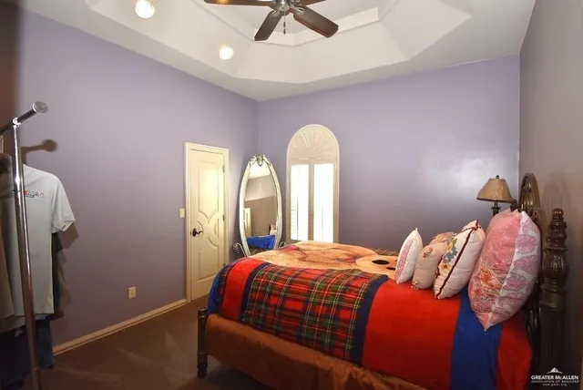 a bedroom with a bed and a mirror