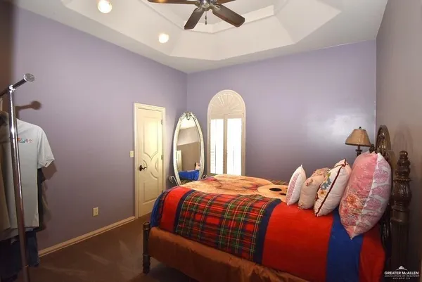 a bedroom with a bed table and a window