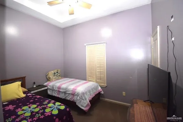a bedroom with a bed and ceiling fan