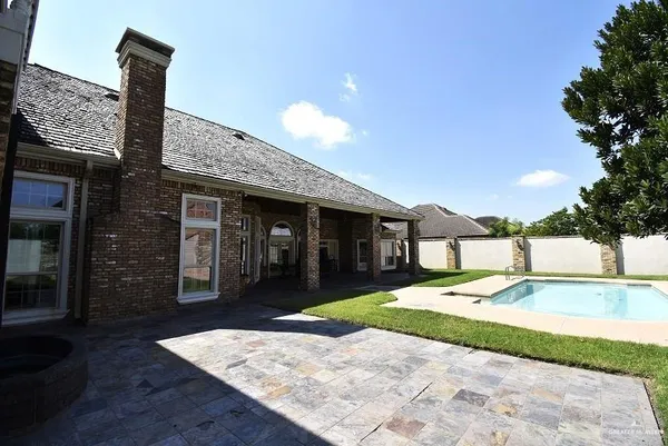 a view of a backyard with swimming pool
