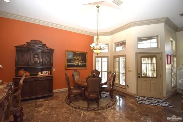 a view of a dining room with furniture wooden floor and chandelier