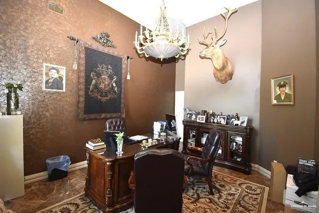 a dining room with wooden floor a chandelier a wooden table and chairs
