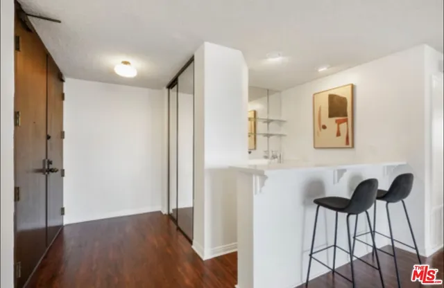 a view of kitchen with furniture and wooden floor