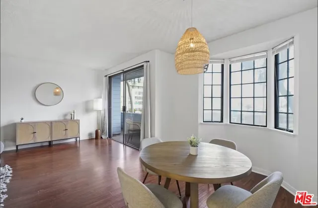 a view of a livingroom with furniture window and wooden floor