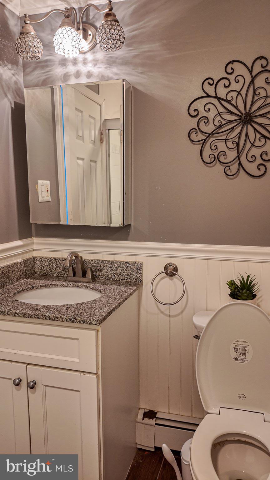 3503 Brookview Road Philadelphia, PA 19154 - Photo 16 of 30 a bathroom with a granite countertop toilet sink and mirror