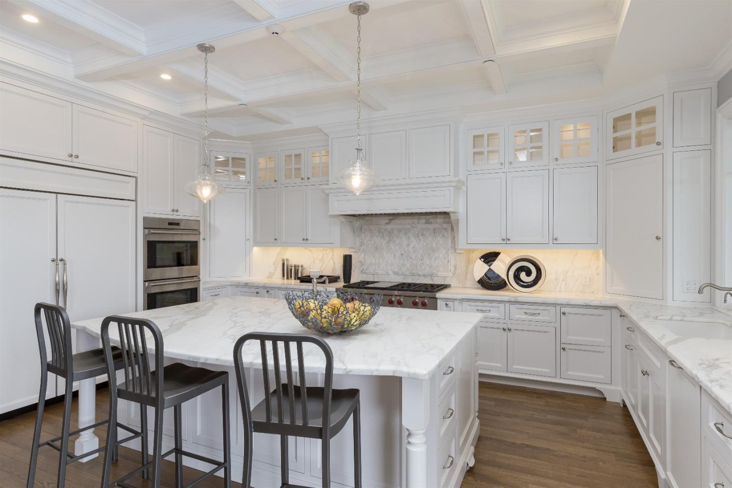 14966 Sobey Road Saratoga, CA 95070 - Photo 24 of 60 a kitchen with a dining table chairs stove and white cabinets