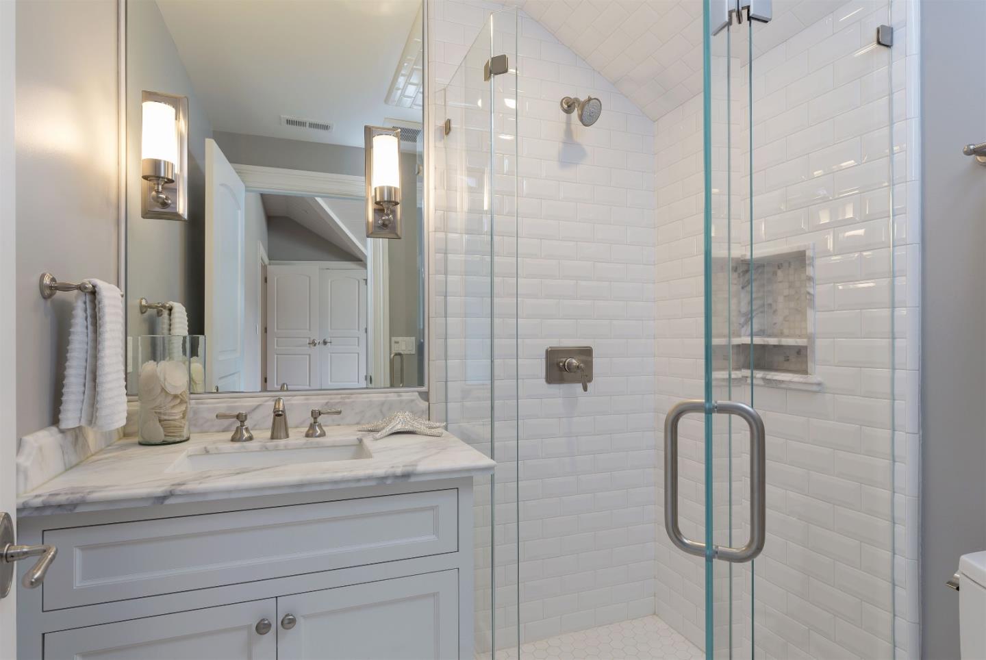 14966 Sobey Road Saratoga, CA 95070 - Photo 44 of 60 a bathroom with a granite countertop shower sink vanity and mirror