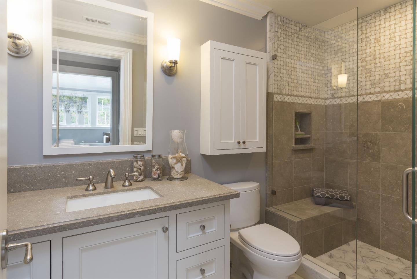 14966 Sobey Road Saratoga, CA 95070 - Photo 48 of 60 a bathroom with a granite countertop toilet a sink a mirror a shower and vanity