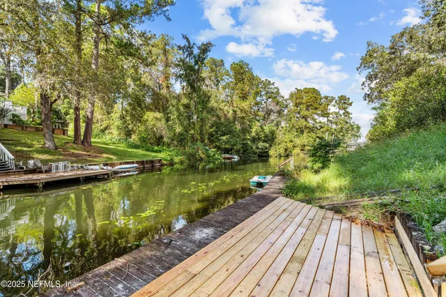 a view of a lake with wooden floor and outdoor space