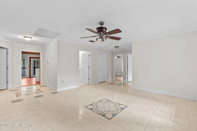 a view of a livingroom with a chandelier fan