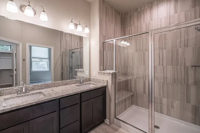 a bathroom with a double vanity sink and a mirror