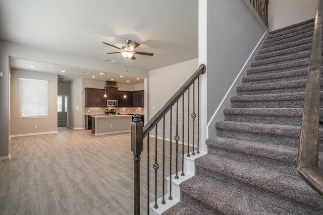 a view of staircase and kitchen with wooden floor and a kitchen view