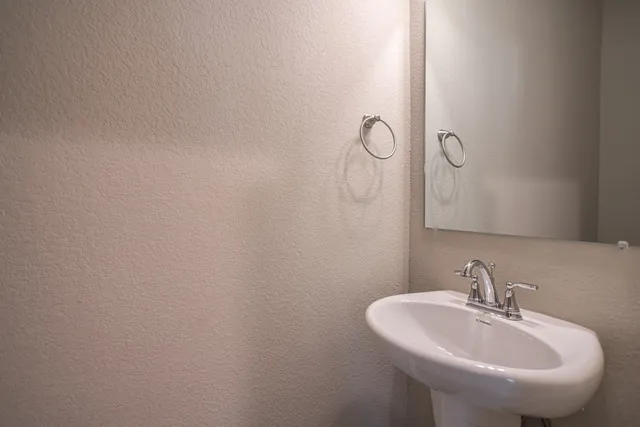 a bathroom with a sink and mirror