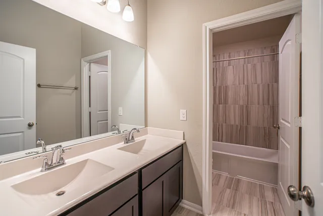 a bathroom with a sink a vanity and a mirror