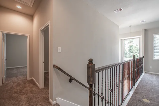 a view of a hallway with window and stairs