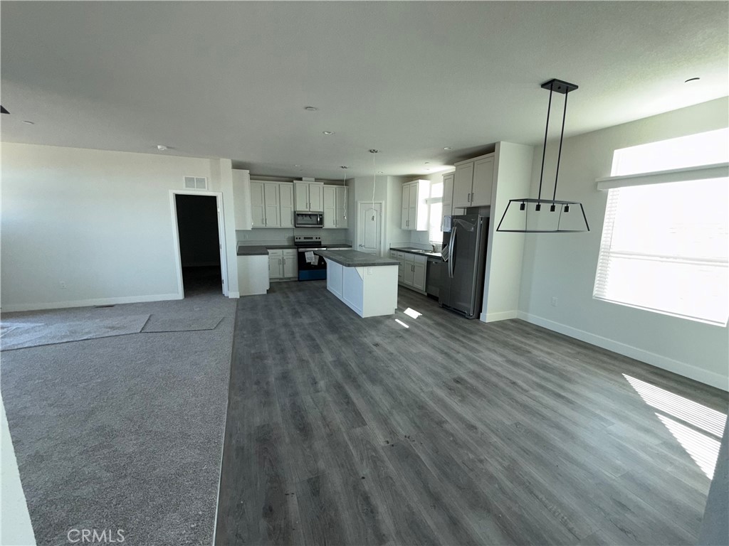 10633 Bromley Road Pinon Hills, CA 92372 - Photo 4 of 13 a kitchen with refrigerator and window