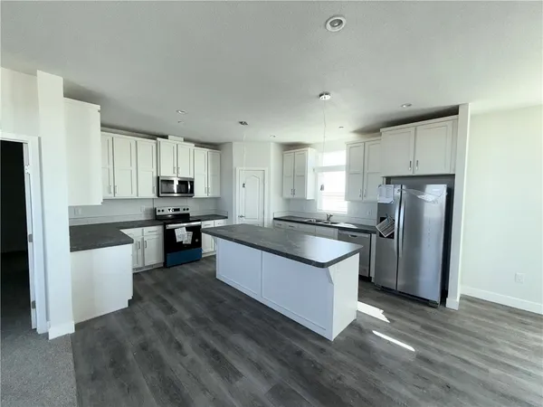 a view of a kitchen with a sink and a stove top oven