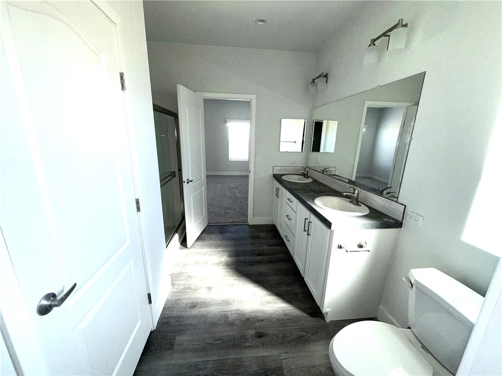 10633 Bromley Road Pinon Hills, CA 92372 - Photo 7 of 13 a bathroom with a granite countertop sink mirror vanity and toilet