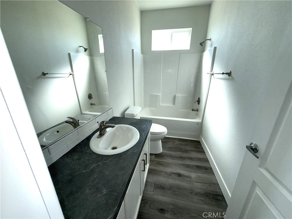 10633 Bromley Road Pinon Hills, CA 92372 - Photo 8 of 13 a bathroom with a sink a toilet a mirror and shower