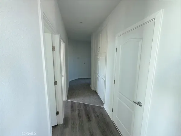 a view of an empty room and closet area