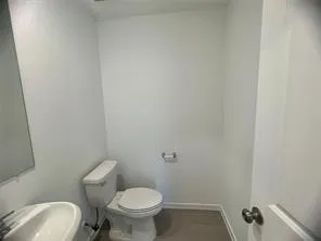 a white toilet sitting next to a shower