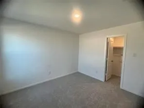 an empty room with a empty space and windows