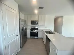 a kitchen with stainless steel appliances a refrigerator and a sink