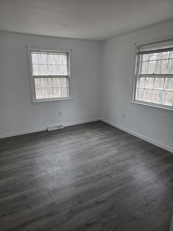6 French Street, Unit AA Billerica, MA 01821 - Photo 14 of 16 an empty room with wooden floor and windows