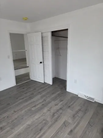a view of wooden floor and entryway in a room