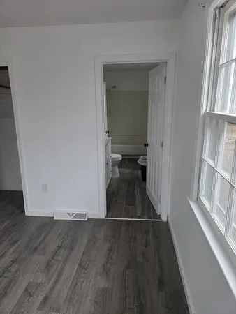 a view of a hallway view with wooden floor and staircase